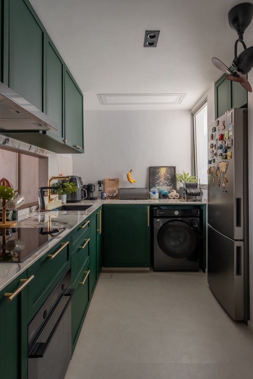 A Green Thread — compact kitchen with forest-green cabinetry