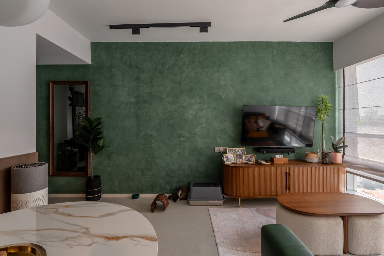 A Green Thread — living room with green textured wall and warm timber console